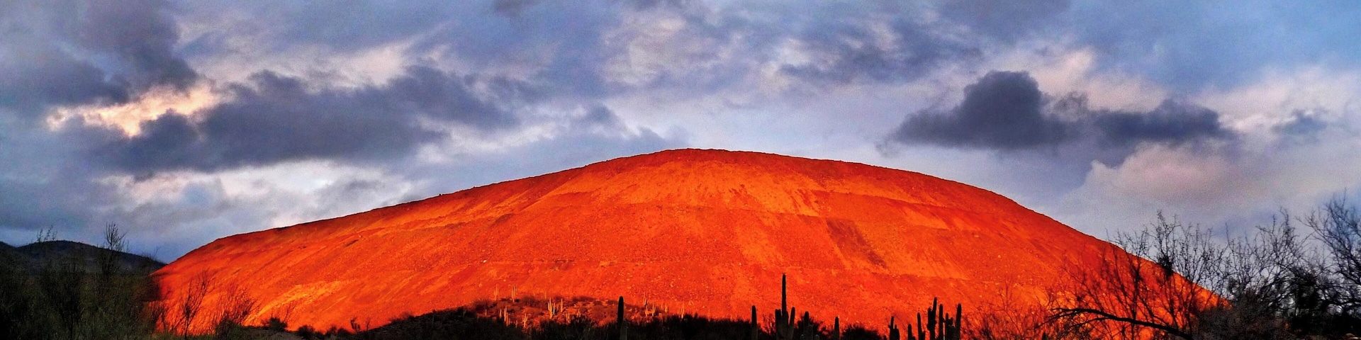 Every once and awhile the sun and clouds provide this stunning view of  the mine trailing mounds.