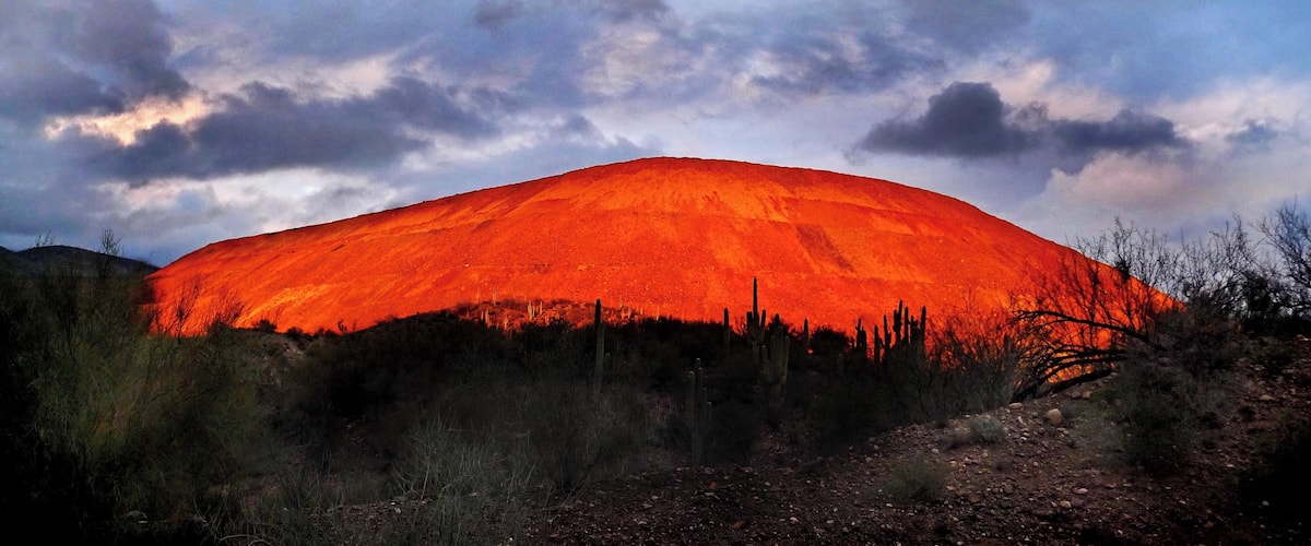 Every once and awhile the sun and clouds provide this stunning view of the mine trailing mounds.