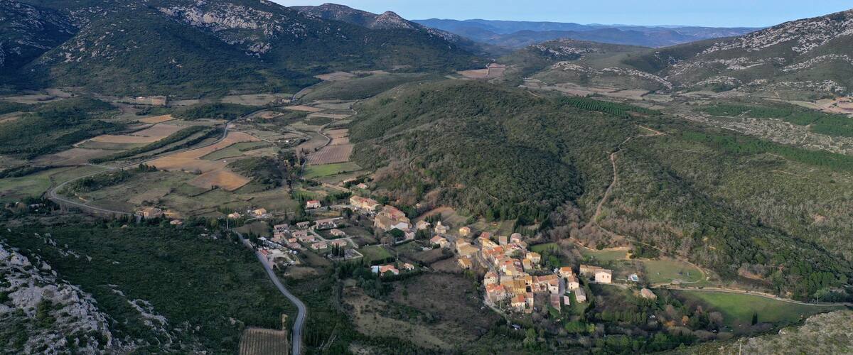 A mountainous landscape with a village nestled in the valley.
