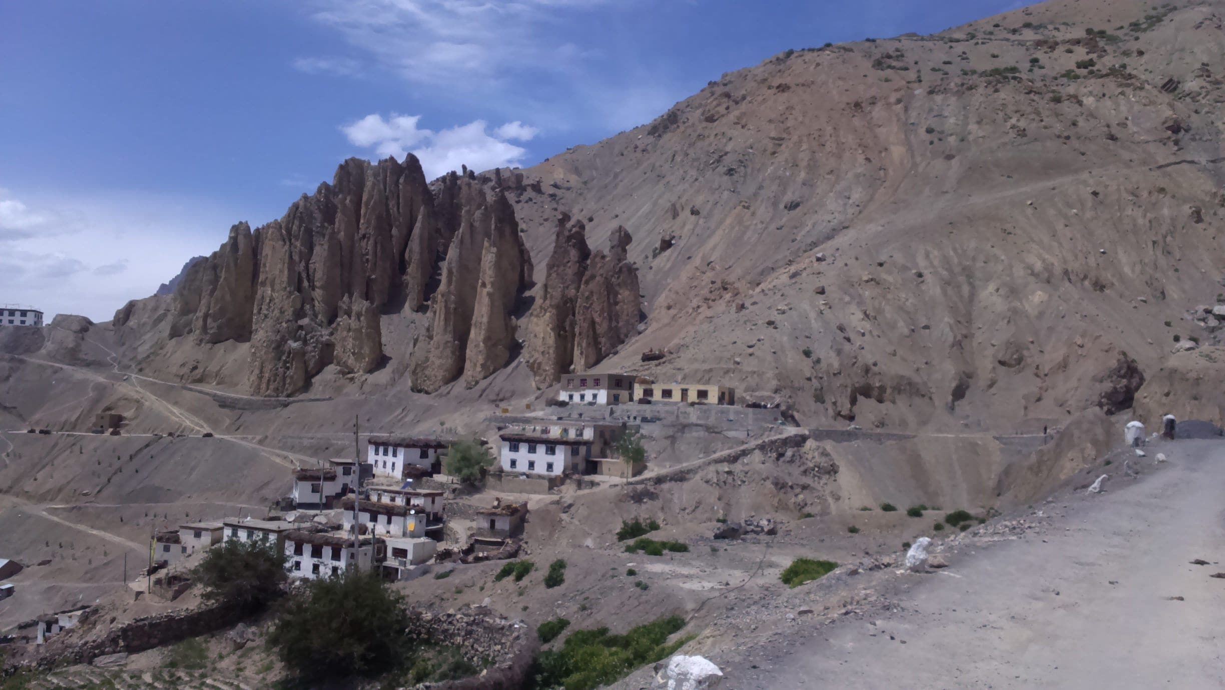A mountainous landscape with a monastery complex nestled in the valley.