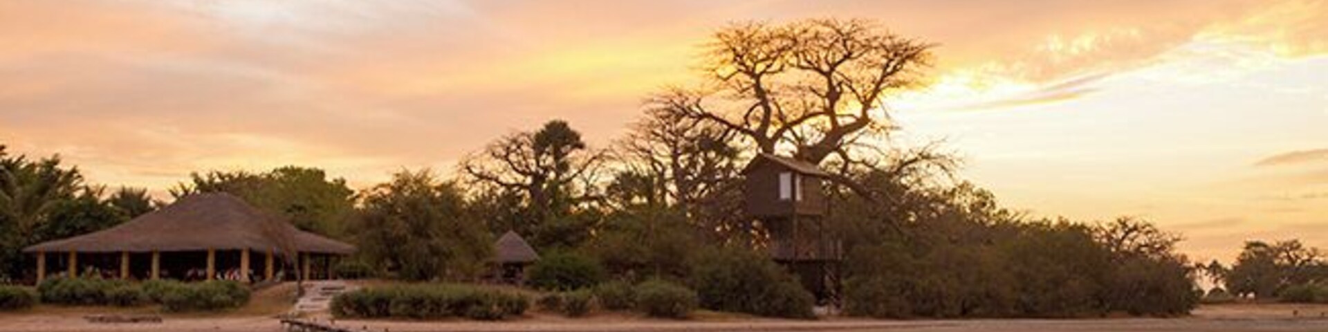 Lodge de Niassam is a eco lodge in paradise! You can live in 3 different cabins; hut on stilts in the lagune, a tree hut in a Baobab tree or a beautiful cabin on the ground. The restaurant building to the left.
Read more on: http://www.travelwithallsenses.com/lodge-de-niassam-eco-lodge-paradise/