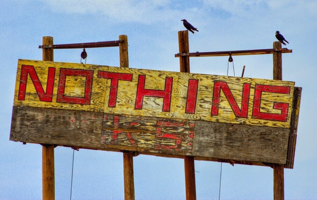 A wooden sign with the word "NOTHING" in red letters.