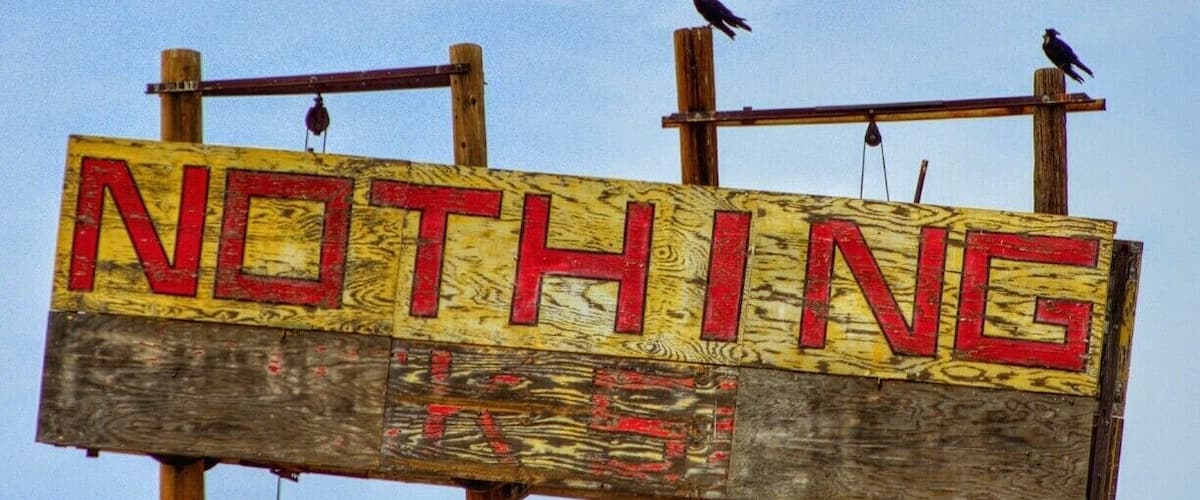 A wooden sign with the word "NOTHING" in red letters.