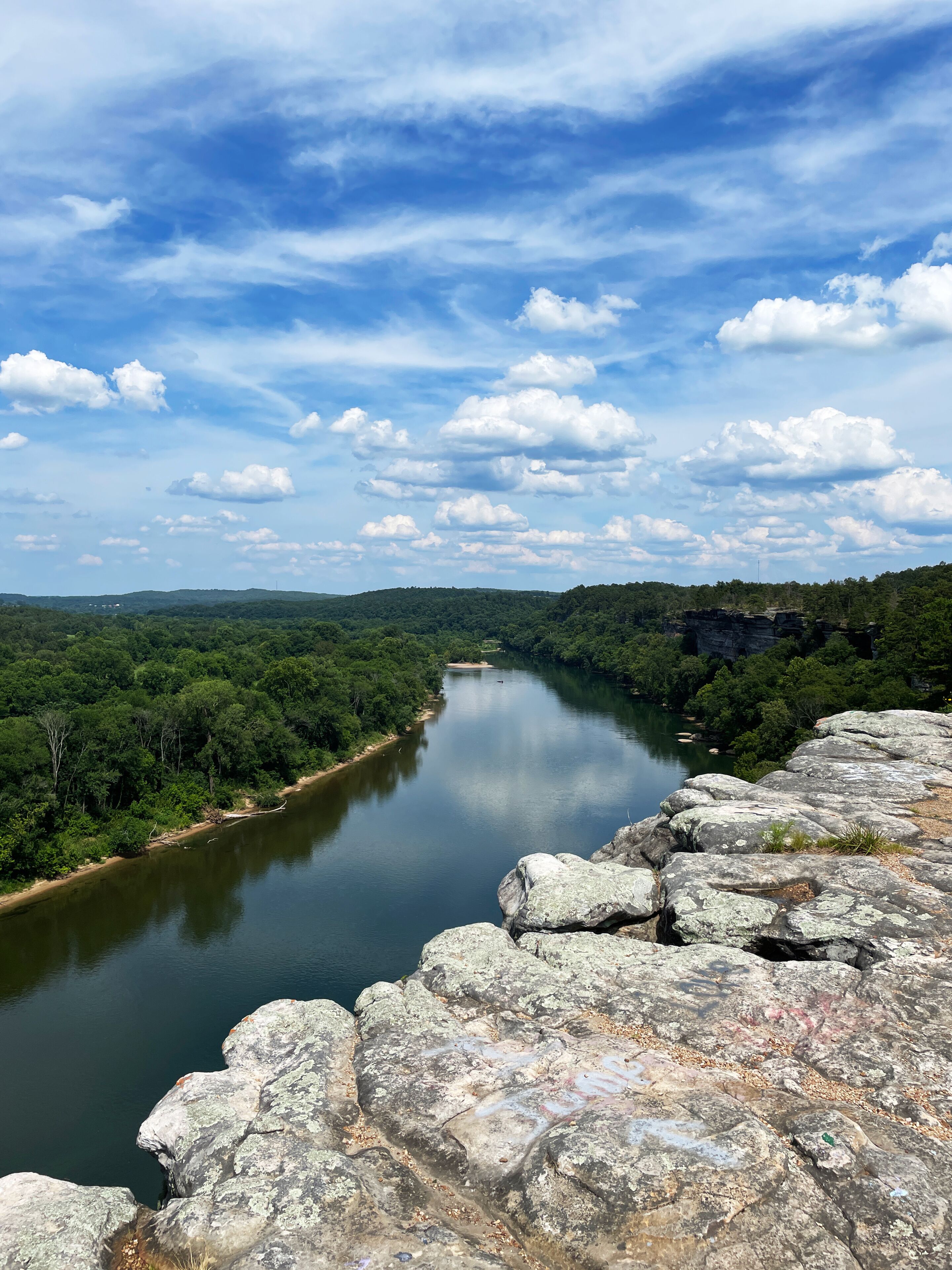 City Rock Bluff in Calico Rock Arkansas overlooking the White River in summer with a blue sky and clouds vertical