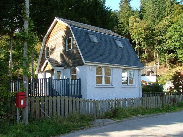 Site of former village shop This building on the main road in Dalguise, replaces the village shop which stood here for years. It was run by Donald Smollet and his wife in the late fifties and early sixties. Much of my hard earned pocket money was spent here. The present building was, for a time, an architects office, but now appears to be vacant.