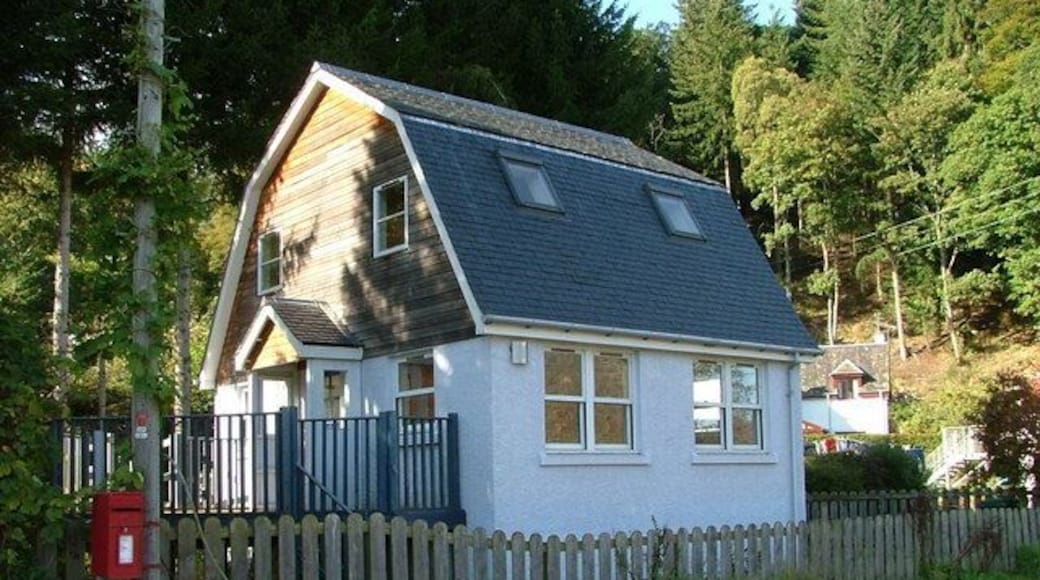 Site of former village shop This building on the main road in Dalguise, replaces the village shop which stood here for years. It was run by Donald Smollet and his wife in the late fifties and early sixties. Much of my hard earned pocket money was spent here. The present building was, for a time, an architects office, but now appears to be vacant.