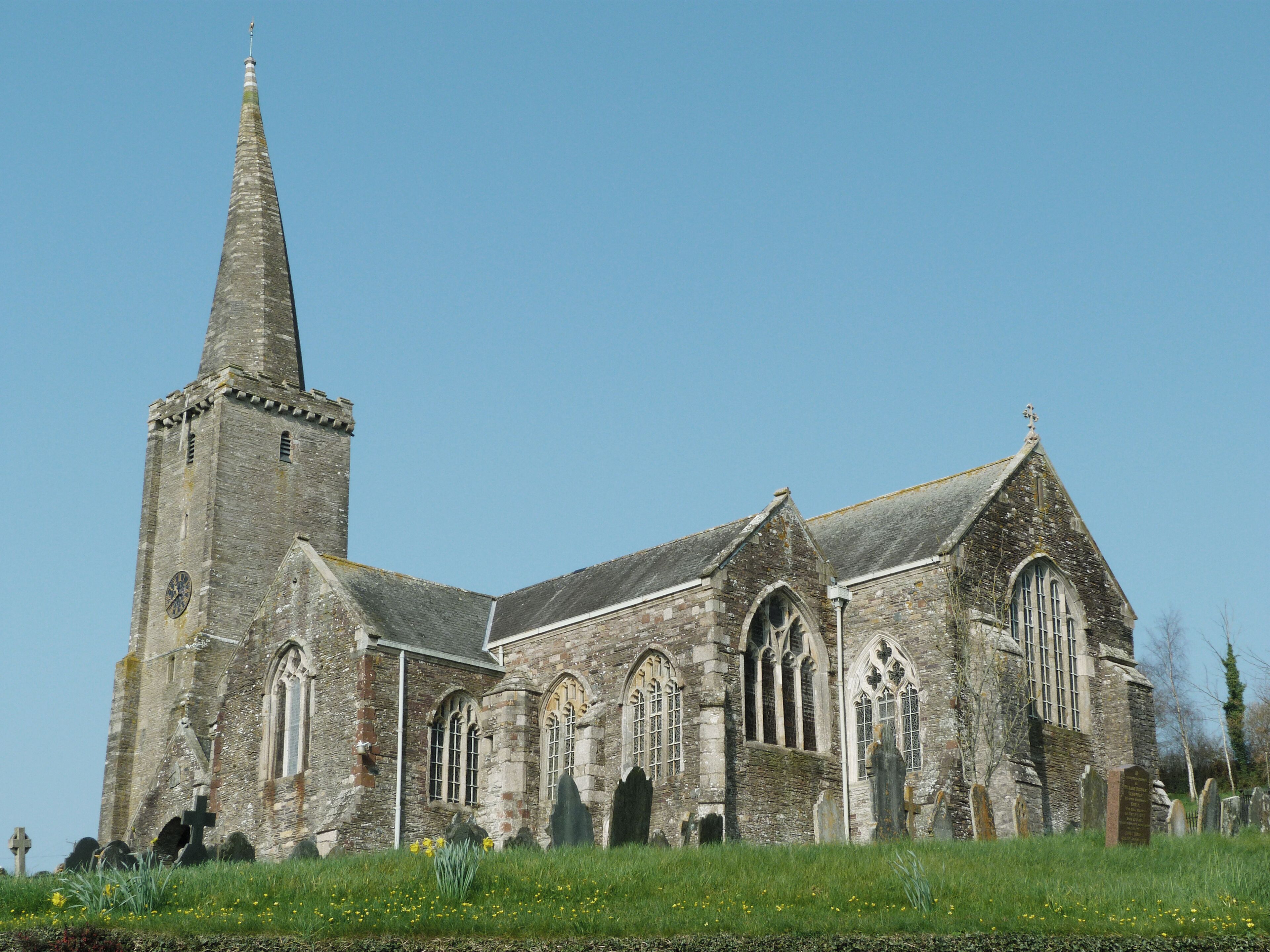 An old church with a tall tower and arched windows.