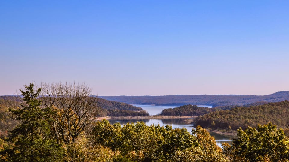 A lake surrounded by forested hills.