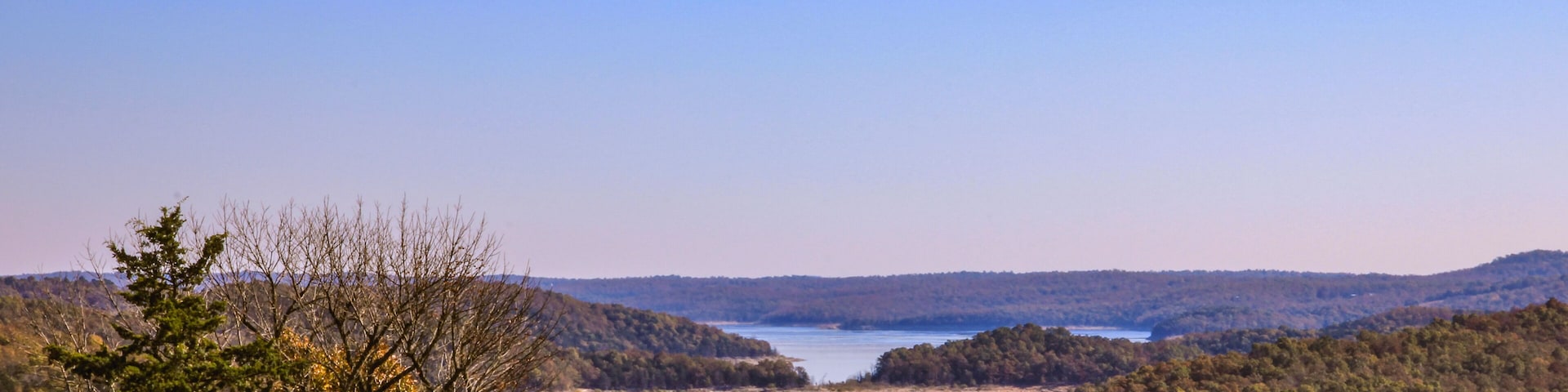 A lake surrounded by forested hills.