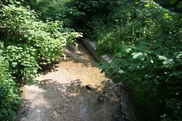 Reinforced river bank The bridge over the River Stour here is on a sharp bend so the bank has to be reinforced to stop the path of the river moving sideways.