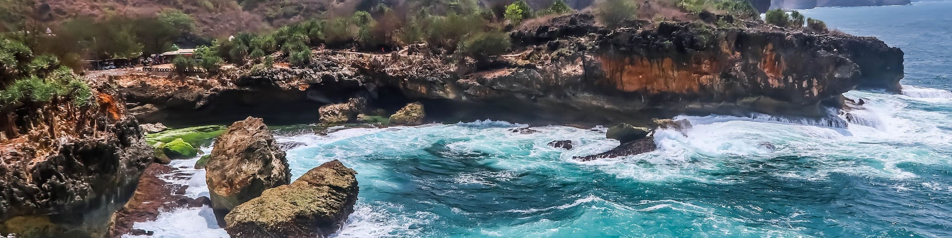 The cliff edge of a beach with big waves during the day