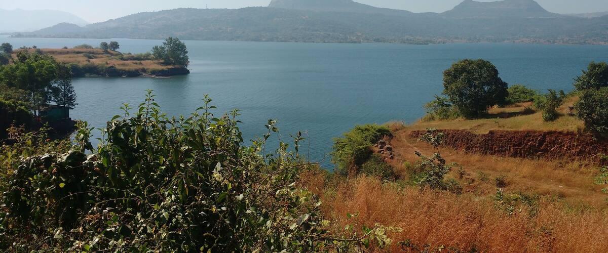 A lake surrounded by hills and trees.