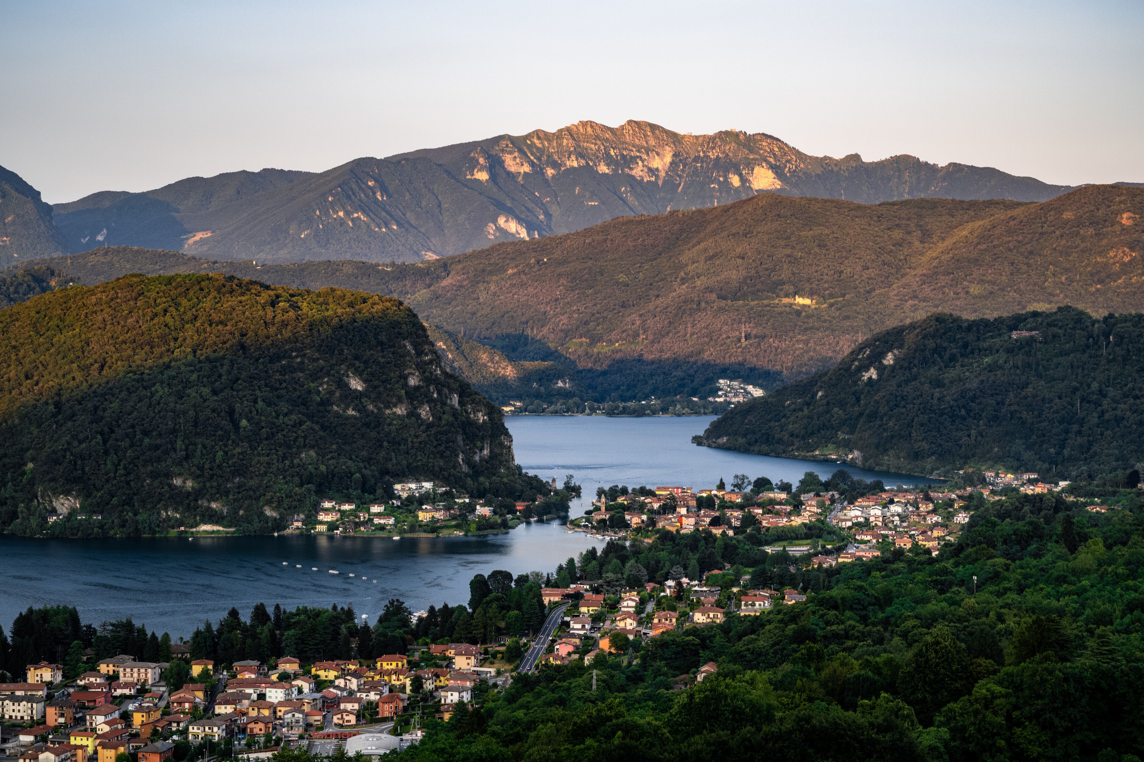 A town nestled between mountains and a lake.