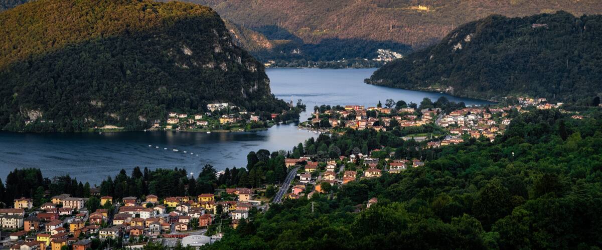 A town nestled between mountains and a lake.