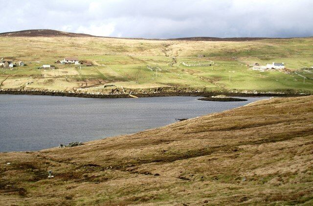 East Burra Firth, Aith Voe, Shetland. Photo taken looking north across East Burra Firth with the remains of a Broch just off the foreshore on the far side.