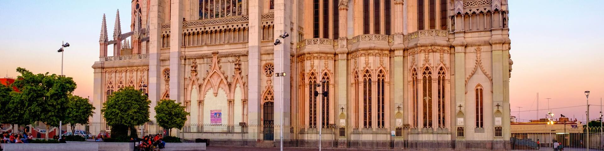 A large Gothic cathedral with intricate architecture, including pointed arches and a prominent rose window.