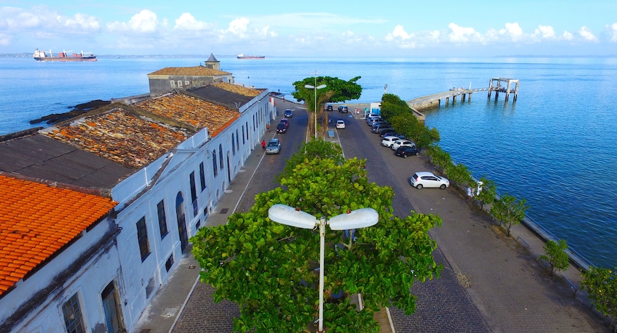 Aerial view of Monserrate historical buildings and pier with the sea in the background.