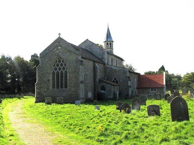 A stone church with a spire and a graveyard.
