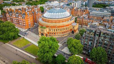 Aerial view of the Royal Albert Hall in London, surrounded by classic red-brick buildings, roads, and green trees