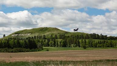View of Salem Sue on hill against cloudy sky
