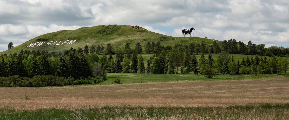 A hill with 'NEW SALEM' written on it, surrounded by trees and fields.