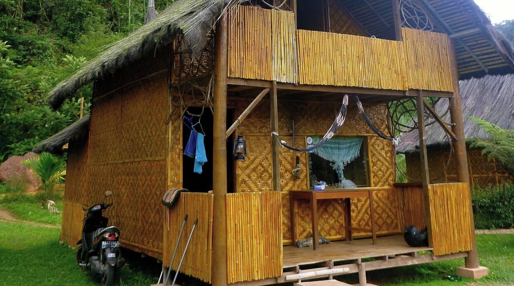 Harau Valley, Sumatra, Indonesia
We stayed at Abdi Homestay, one of only three other homestays in the area that we could see. It consists of five bungalows (one attached to kitchen) that in one direction faces a rice field and the other is against a sheer cliff with a waterfall. Itâs the perfect setting to sit back in one of their hammocks and relax and read a book.
The bungalows are extremely spacious with a large bed downstairs, a clean washroom with Western toilet and mandi shower and a loft upstairs with another bed and a small patio. There is always a flask of boiling water on your table for all day tea and coffee.
At 120,000 rupiah per night (that's $12 Canadian!) it was a sweet escape.
#indonesia #sumatra #bungalow
http://kileetravels.com/harau-valley