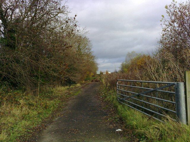 Former A421, Tingewick A disused section of the former A421 looking east. A lorry can be seen in the distance travelling south west along the modern version.