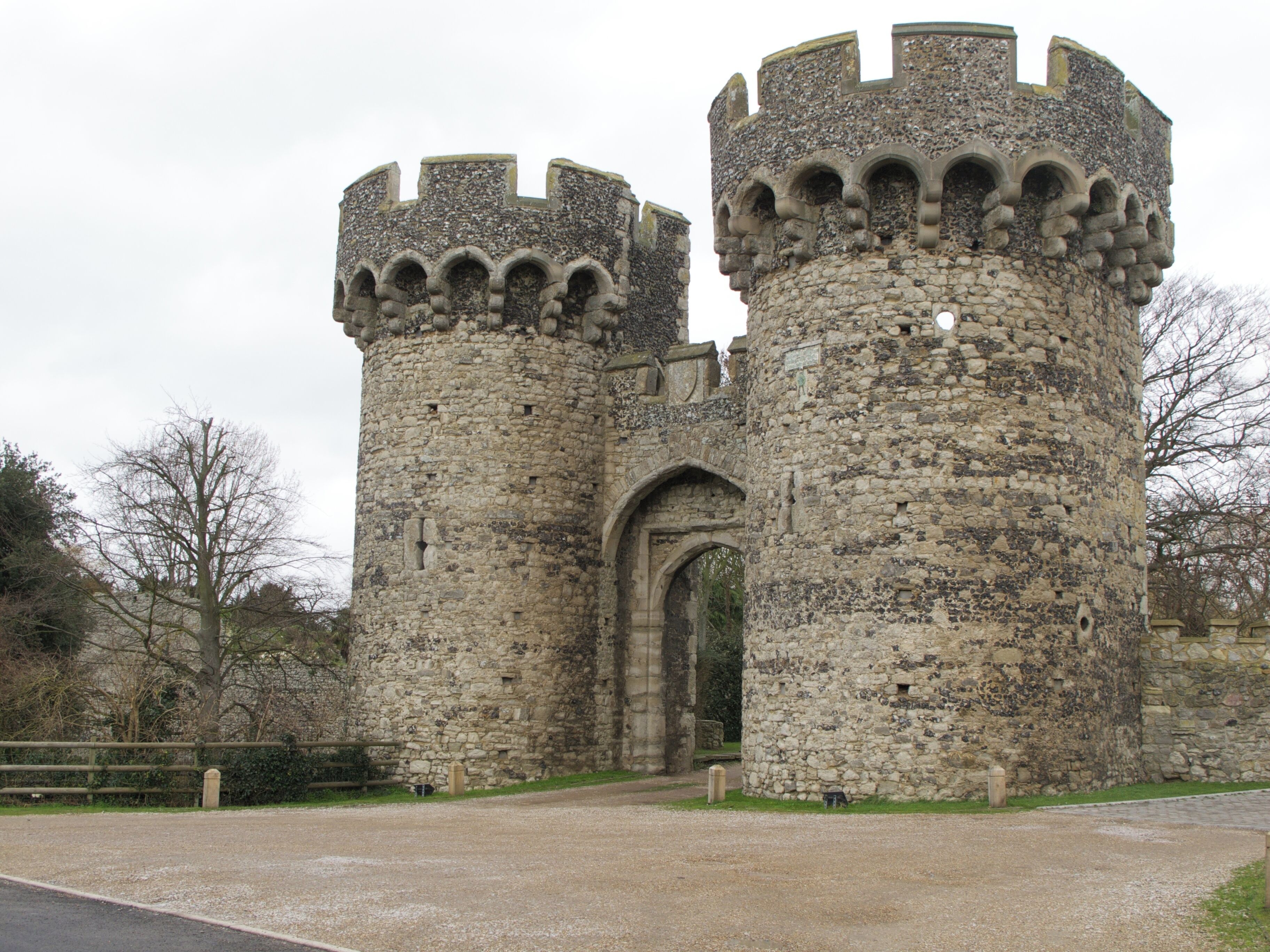 A medieval stone castle with two prominent towers and a large arched entrance.
