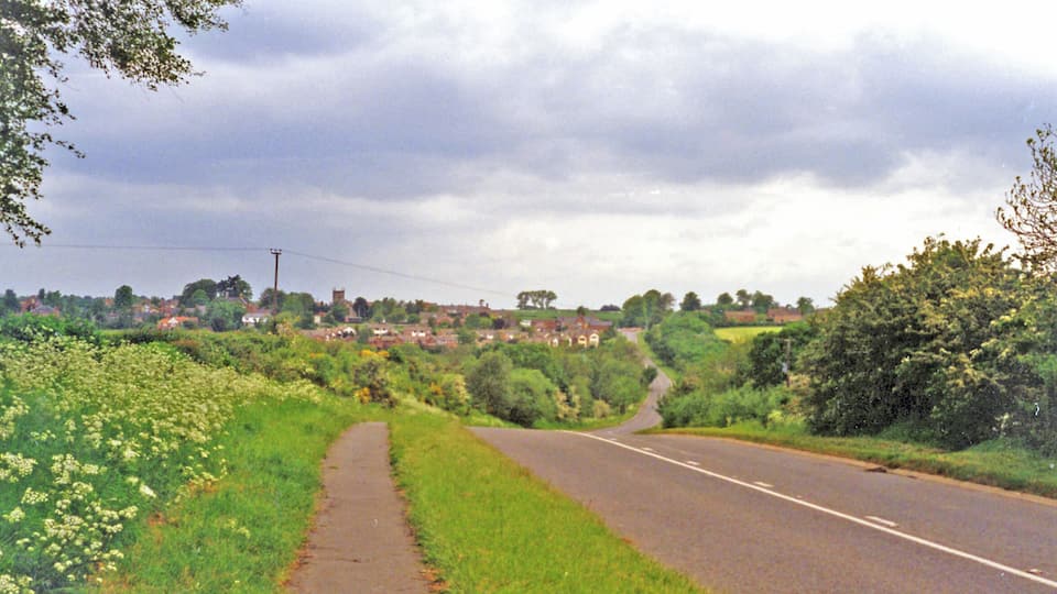 Site of Heather & Ibstock station. View westward, towards Heather on the B591 from Ibstock: the station had been in the dip ahead. It was on the ex-LNWR & Midland Joint (Ashby & Nuneaton) line from Nuneaton via Shackerstone (to left) to Coalville and Loughborough (right), the Charnwood Forest line. The station closed 13/4/31, but the line remained for goods until 7/10/63.