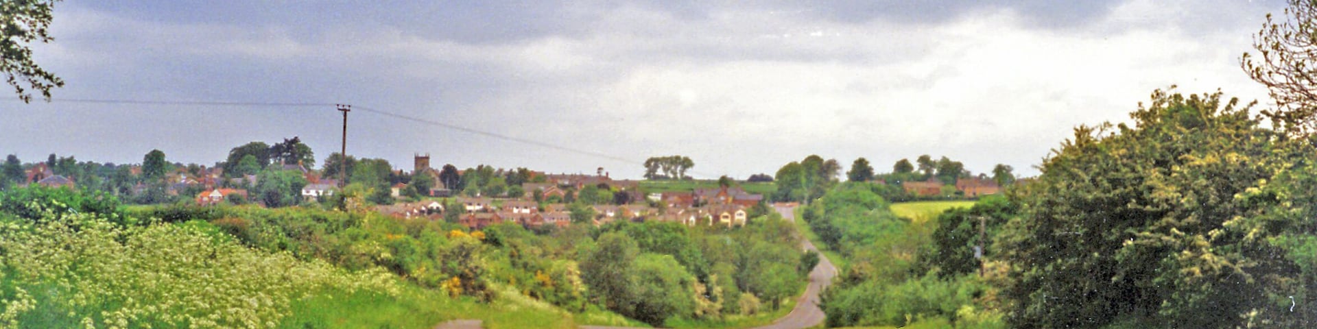 Site of Heather & Ibstock station. View westward, towards Heather on the B591 from Ibstock: the station had been in the dip ahead. It was on the ex-LNWR & Midland Joint (Ashby & Nuneaton) line from Nuneaton via Shackerstone (to left) to Coalville and Loughborough (right), the Charnwood Forest line. The station closed 13/4/31, but the line remained for goods until 7/10/63.