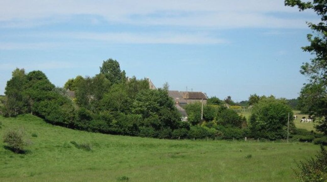 Lake Farm and cottages Valley with small meandering stream in foreground.