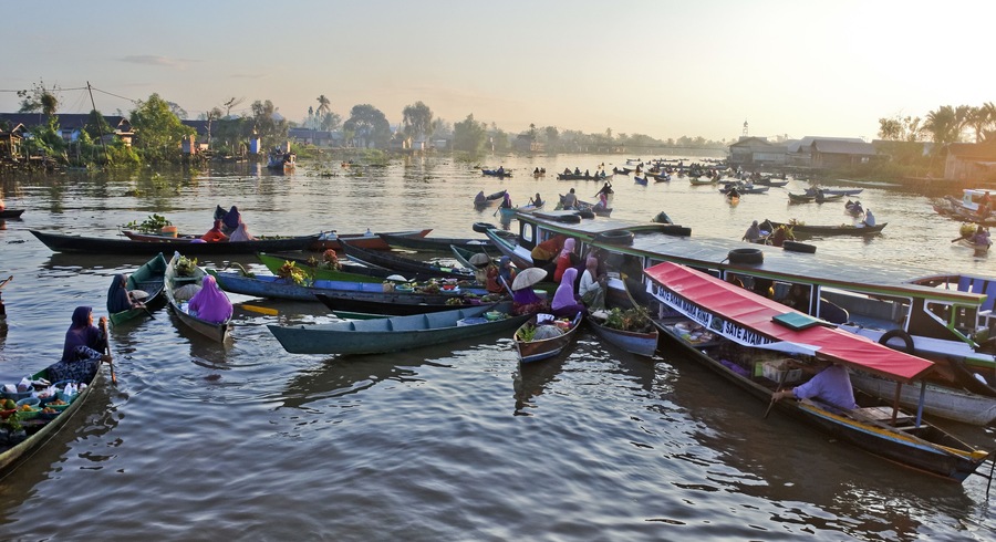 Banjarmasin, July 2022. Busy Lok Baintan floating market in the morning. Merchants offer their wares to tourists