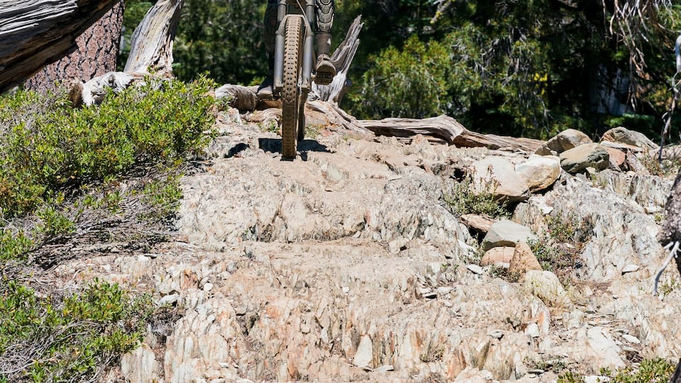 female mountain biker on rock garden