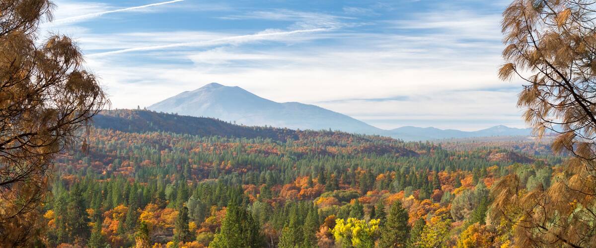 A mountainous landscape with autumn foliage.
