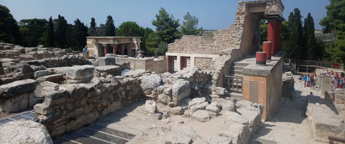 Ancient ruins with stone columns and a partially intact building.