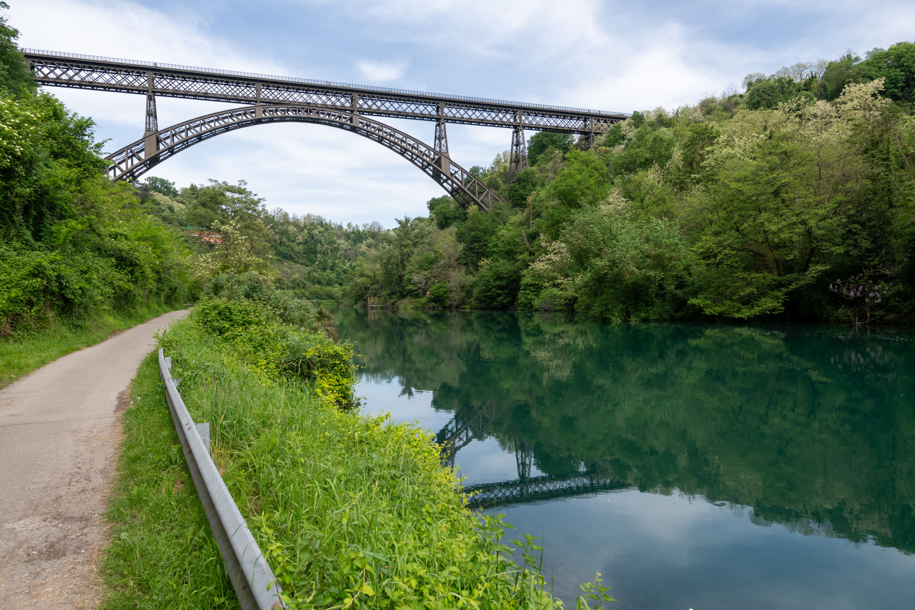 A river with a bridge in the background.