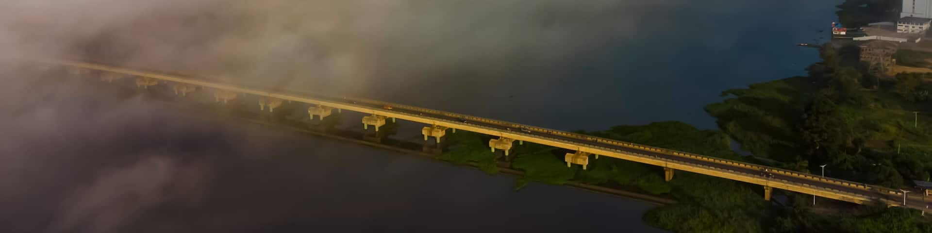 Aerial view of the beautiful Lower Volta Bridge over a foggy river landscape, Sogakope, Ghana.