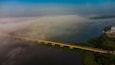 Aerial view of the beautiful Lower Volta Bridge over a foggy river landscape, Sogakope, Ghana.