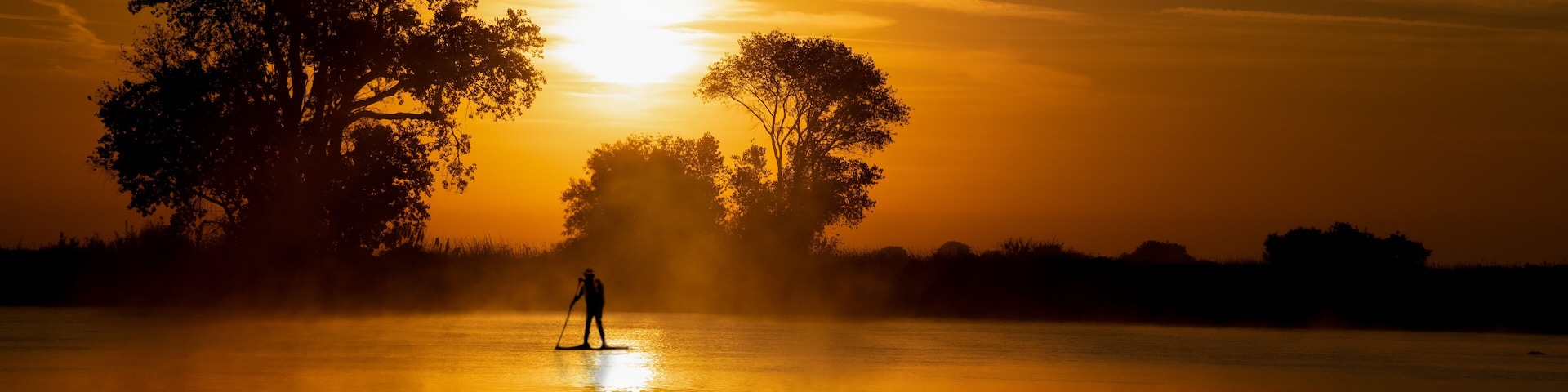 Great time for a workout paddle boarding on the delta river in Isleton Ca. in the early morning in fall autumn