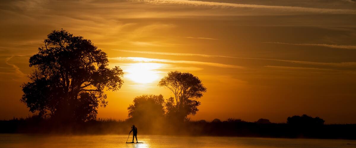 Great time for a workout paddle boarding on the delta river in Isleton Ca. in the early morning in fall autumn