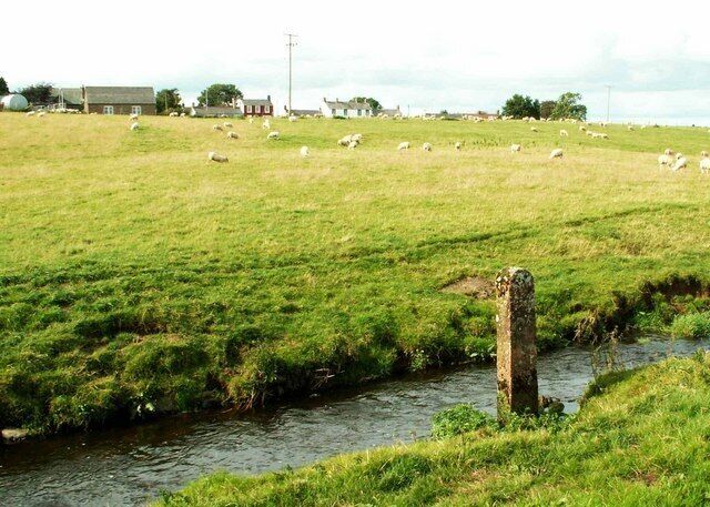 Burn and fields at Dornock There were no markings to be seen on this stone; perhaps it's just a gatepost in an unconventional setting.