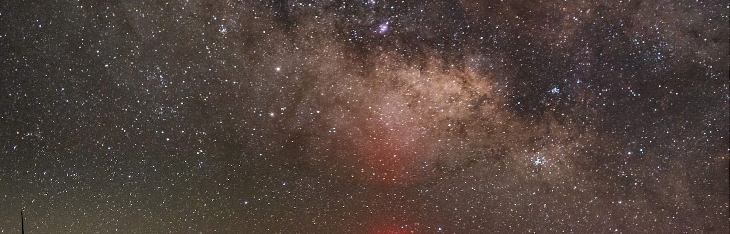 The core of the Milky Way rises above the dome of the FAA radar dome