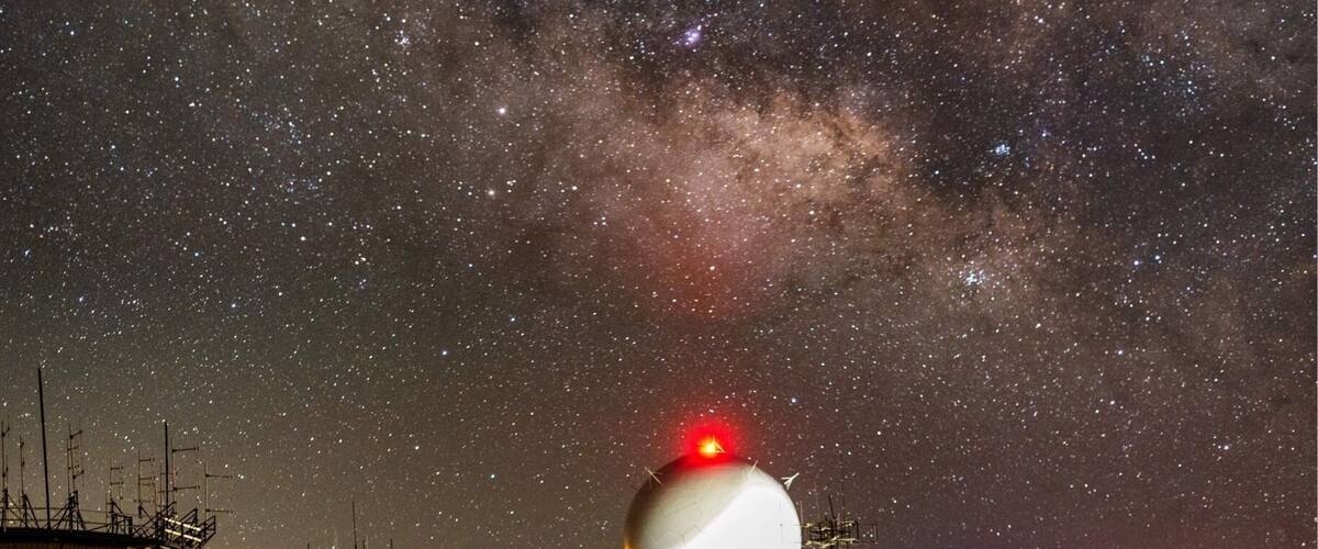 The core of the Milky Way rises above the dome of the FAA radar dome