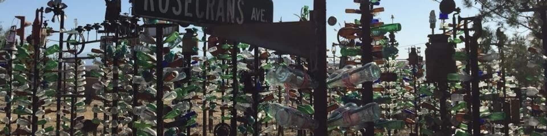 Street signs for Long Beach Blvd., Rosecrans Ave., and Barstow City Limits.
