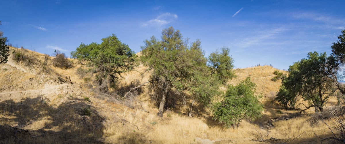 Panorama of walking trail leading through canyons of Santa Clarita California.