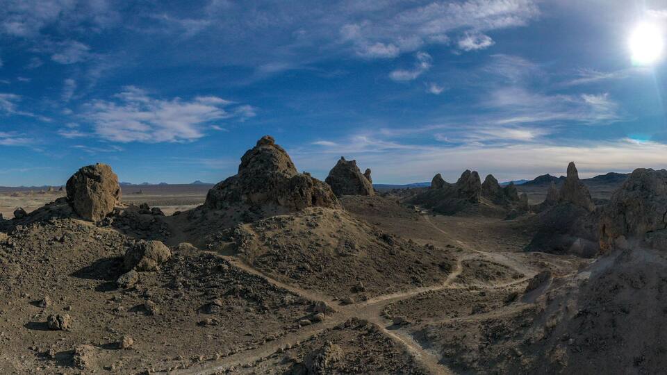 A desert landscape with prominent rock formations and a clear sky.