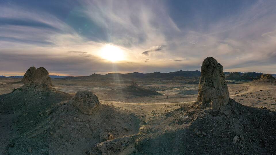 A desert landscape with prominent rock formations under a clear sky.