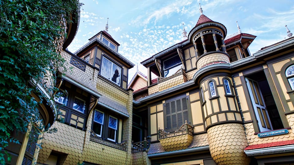 A building with ornate architecture, including a turret and a balcony with a decorative railing.