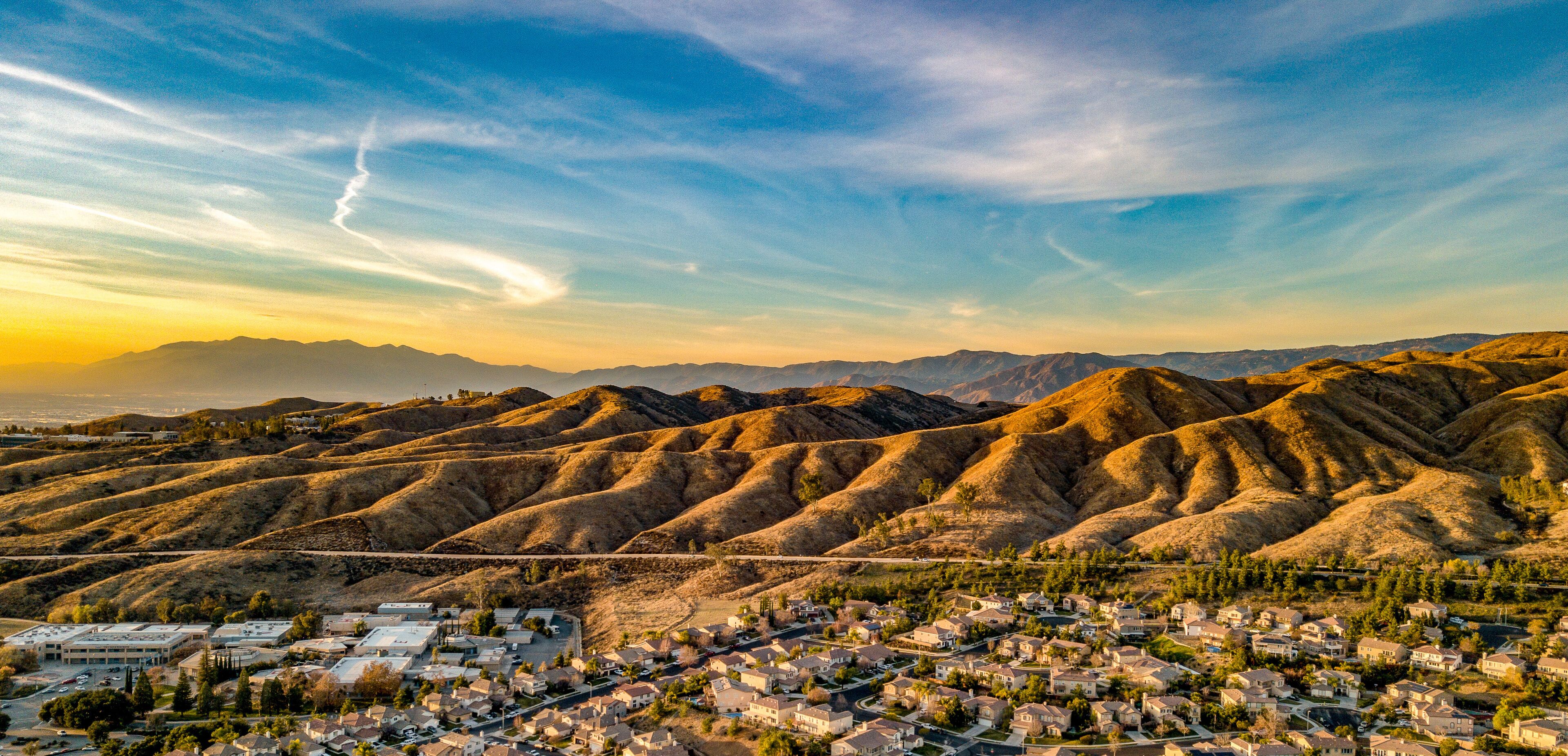 Beautiful Chapman Hills At Dusk With Blue and Yellow Sky And Wisps Of Clouds
