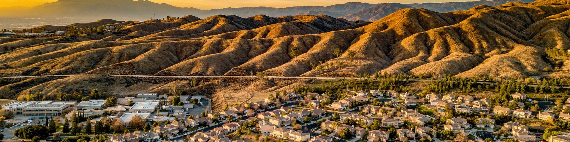 Beautiful Chapman Hills At Dusk With Blue and Yellow Sky And Wisps Of Clouds